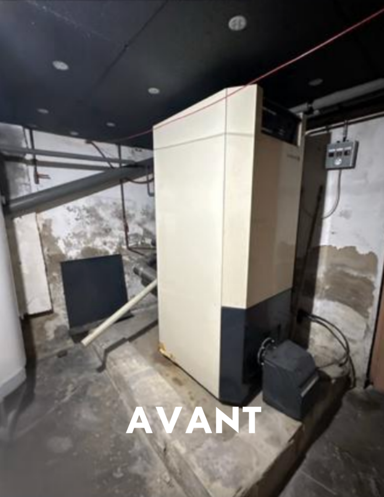 Ancienne chaudière fioul installée dans un sous-sol avant remplacement par une pompe à chaleur.